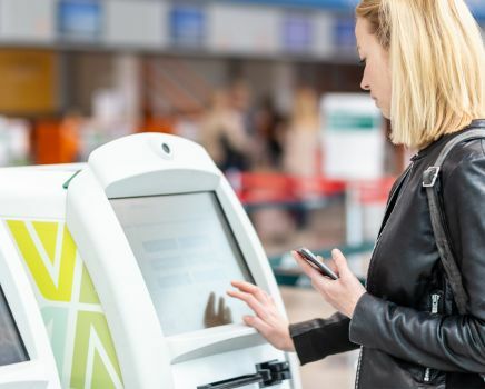 women-using-kiosk-at-public-place