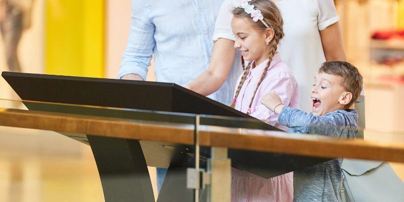 children-all-excited-and-happy-while-interacting-with-a-digital-kiosk-in-museum