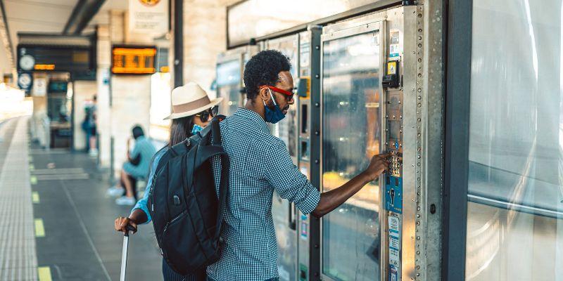 passengers-using-vending-machine-at-train-station