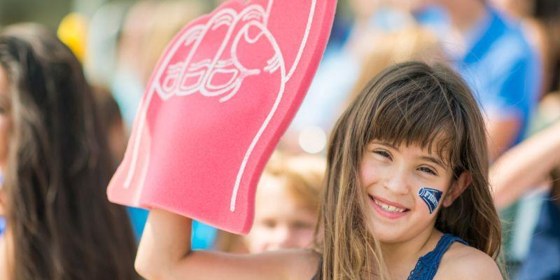 young-sports-fan-having-a-wonderful-fan-experience-and-smiling